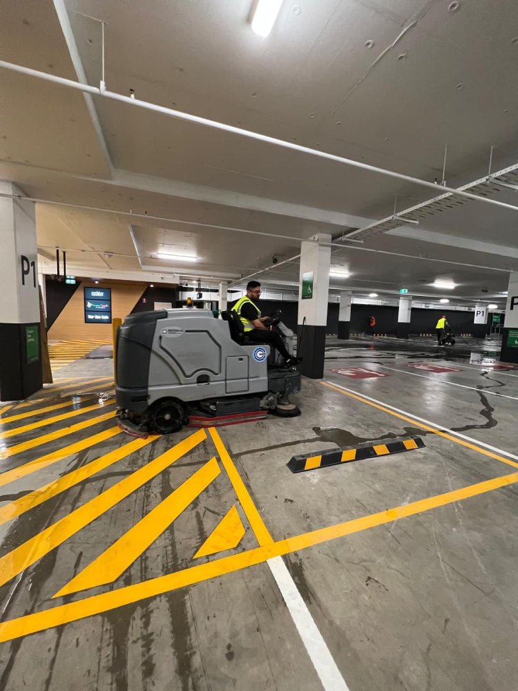 KClean team using industrial floor cleaning equipment